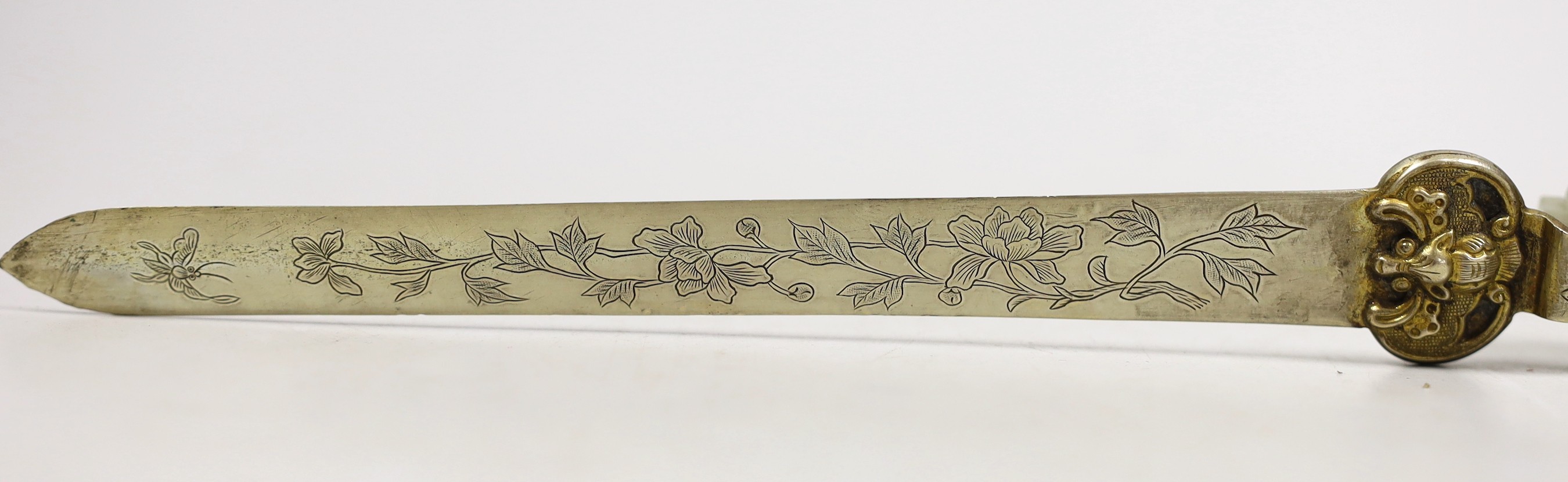 A Chinese celadon jade belt hook handled paperknife, the 19th century belt hook 8.2 cm long, total length 26.5 cm
